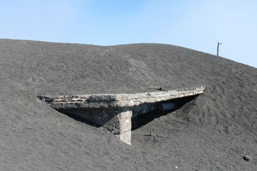 A house near the top of Mount Etna that was partially buried by an erruption in 2003.
