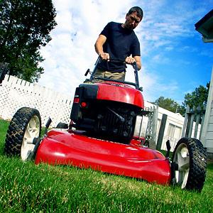 A happy college entrepreneur mowing the lawn!