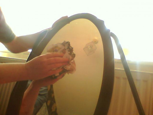 Off with dry news paper, as you can see the mirror is spotless with no fibers on the surface and no streaks.