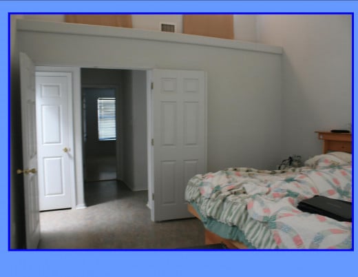 Double doors to Master Bedroom.  Vaulted ceiling with two clerestory windows. Note linen closet in hallway.