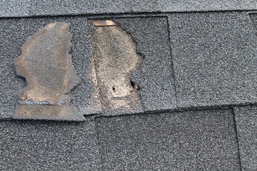 Broken off shingle with exposed nail hole allowing water infiltration