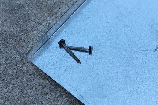 Ring shank nails and screws with rubber gasket make emergency flashing and shingle repairs.