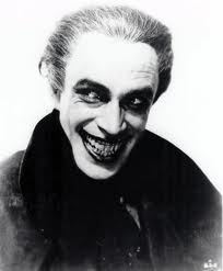 Conrad Veidt in The Man Who Laughs looking very similar to the familiar appearance of the Joker.