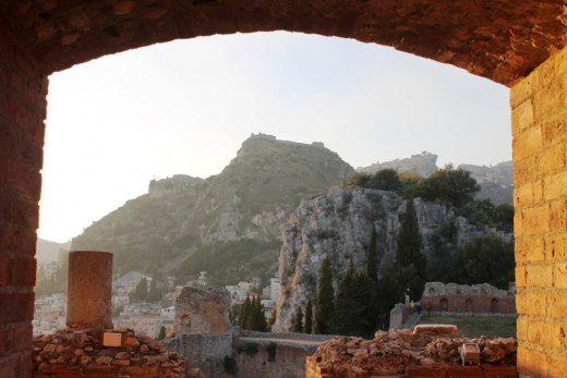 View through the back wall of the amphitheatre to the rugged countryside beyond. 
