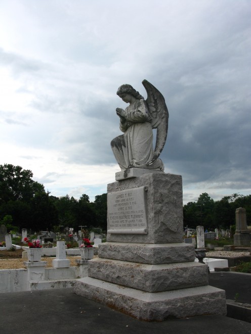 An angel kneels in prayer over the Nix monument