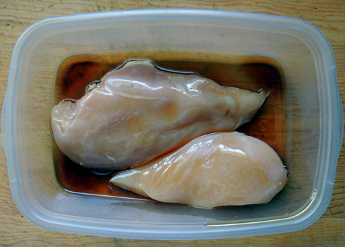 chicken breasts marinating in sesame oil