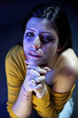 an abused woman praying for help that will never come
