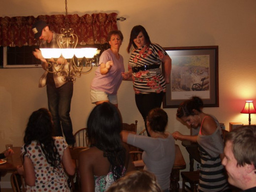 My wife and cast members dancing on our dining room table during a post performance party.  These people are self energizing and don't need ushers.