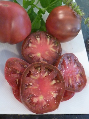 A large pink/black beefsteak-like tomato. Possibly Ukrainian.