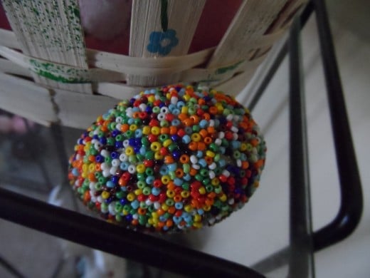 Seed beads glued on a styrofoam egg till fully covered.