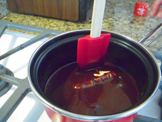 Stir constantly over low heat, just until chocolate and butter melt completely, then remove pan immediately from heat.