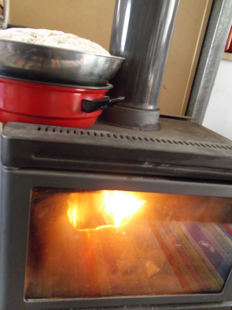 This basic slow combustion heater is put to work helping dough rise. The bowl is elevated from direct heat.