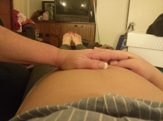 Mom and daughter talking to baby.