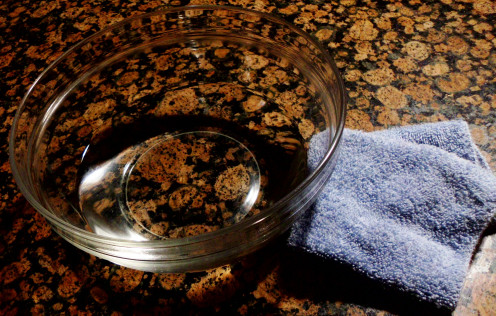 Bowl of water with vinegar and towel