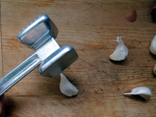 TIP: a meat mallet crushes a clove nicely--enabling easy peeling...