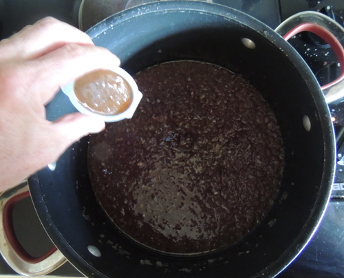 add stock--either cube or concentrate--I'm using concentrate. Simmer for a while to cook off alcohol