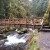 A large wooden bridge crossing the river above the fall. A large wooden bridge crossing the river above the fall.