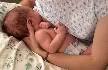 Cradle hold, baby is feeding on the right side, mum has her left hand across baby's body supporting the head, the right hand is then free to assist. 