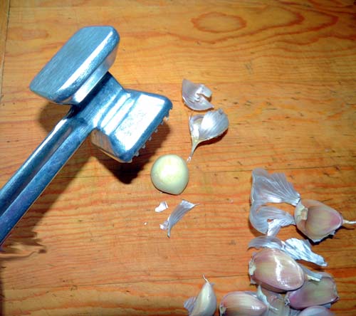 a light tap with a meat mallet cracks garlic peel easily; mince thereafter
