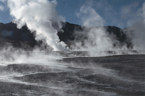 Steam coming out of the ground is a sign of high underground temperatures at the spot; this energy, called geothermal, can be exploitated.