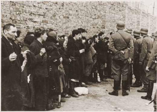 Photo from the Warsaw Ghetto Uprising.  This was a search and interrogation for weapons of captured Jews, before being taken to the Umschlagplatz.  So they were unable to defend themselves and fight back.