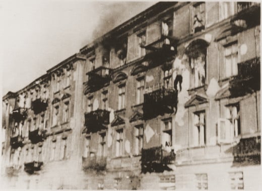 A Jewish man jumps from the top floor to avoid capture.  Warsaw Ghetto.