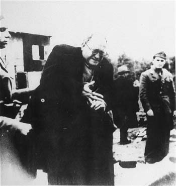 Jewish prisoner being forced to take off a ring as he arrived in the Jasenovac concentration camp.. 
