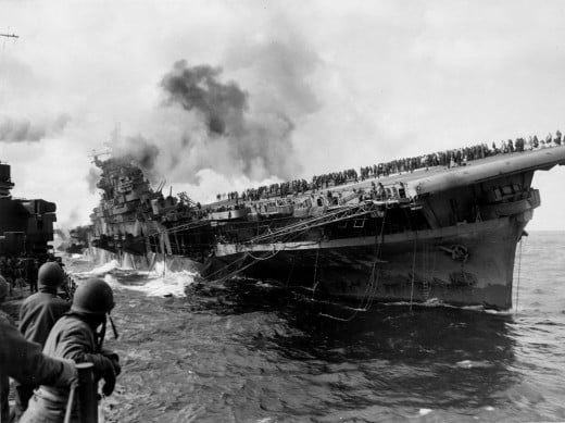 A view of the listing, strickened USS Franklin taken from the cruiser USS Santa Fe.