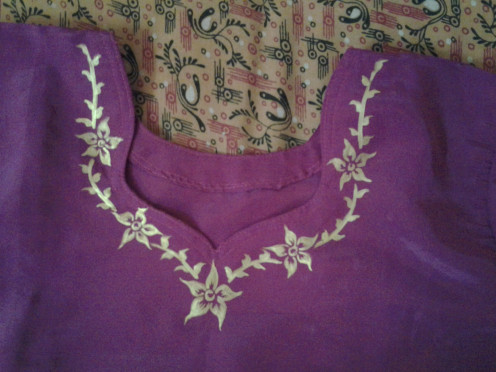 Painting on the neckline of a satin dress