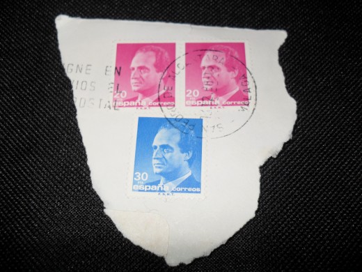 Cut the stamps from the envelope, but leave space. 
