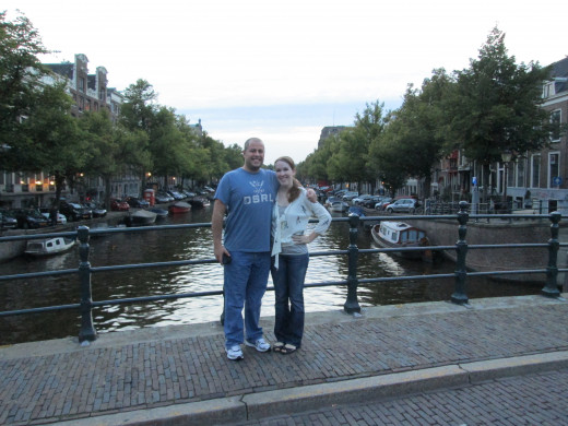 Traveling together can strengthen a married couple's bond and renew romance. (Pictured: My husband and I in Amsterdam, strolling down the canals.)