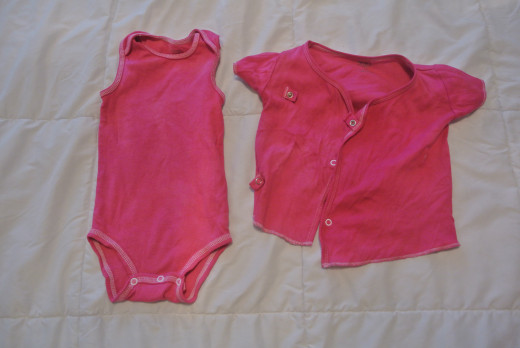 Instead of throwing out these stained white infant clothes, I dyed them a brighter, darker color.  The dye covered up the stains and made them still wearable. 