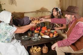Some re-enactors showing Indians and Pilgrims eating together