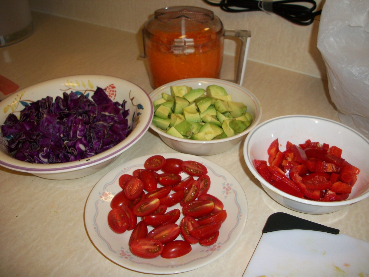 Dice the tomato, avocado, red pepper, red cabbage, and carrots.  Wash and chop the Romain and spinach.