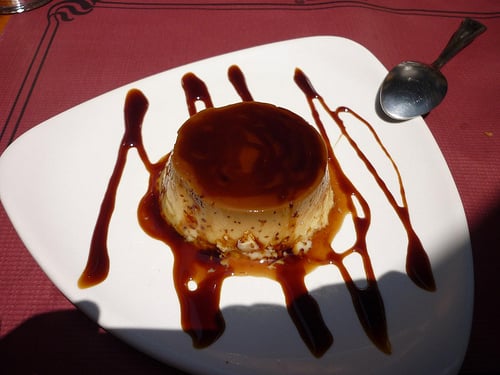 Coffee Flan plated with decorative caramel syrup.