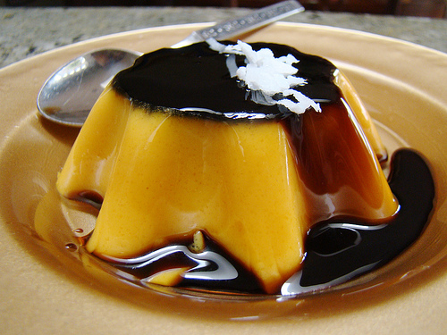 (click source link for vegan flan recipe) Coconut Flan made in starburst custard mold, garnished with coconut.