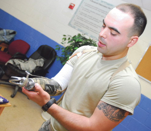 Staff Sgt. Luis Elias lost his right hand 6/2009, but prosthetics and a robotic bionic hand allowed him to return to his military post. 