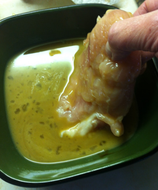 Dip the chicken into the egg mixture