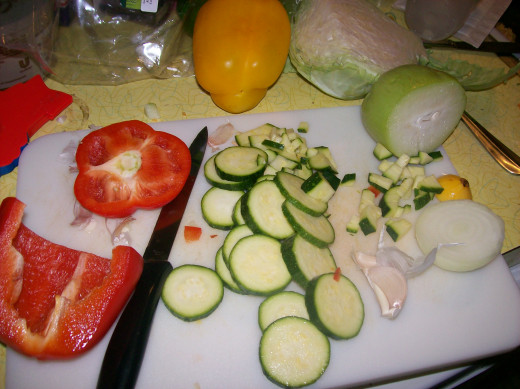 Chopping ingredients. The item on the right before the cabbage is the chayote squash. This was for a different recipe, but I use the same vegetables