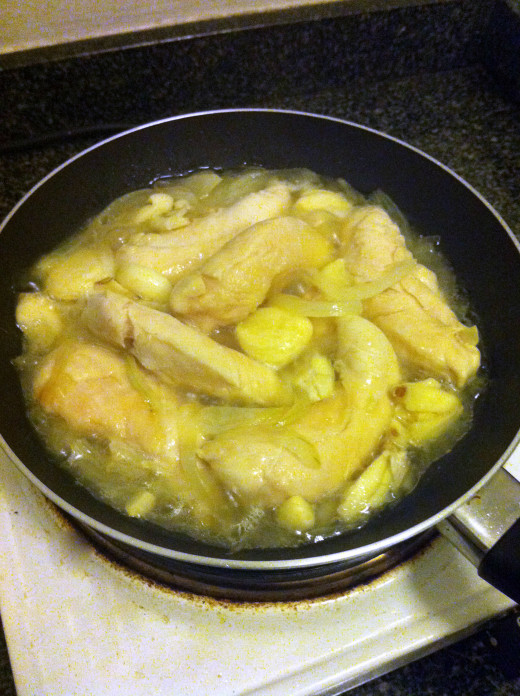 stir-frying the chicken in onions, sprinkled with brown sugar