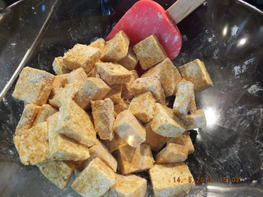 Cube the tofu and toss in the curry mix.