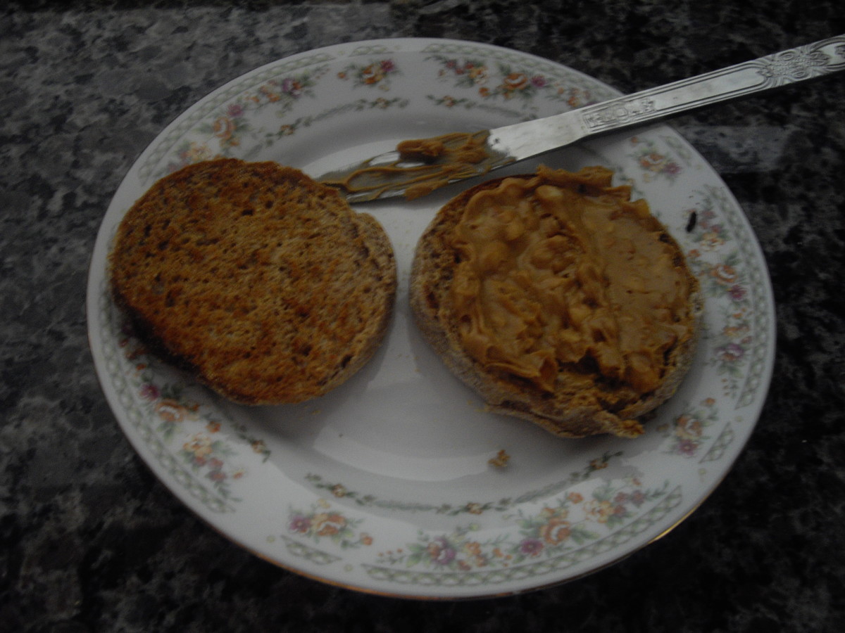 Vespawoolf's "Homemade English Muffins", toasted, one slice shown plain, and the one on the right with peanut butter 