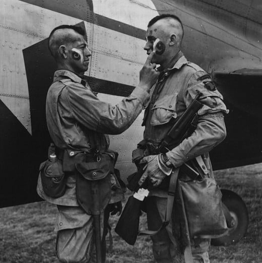 U.S. Paratroopers applying war paint during WWII