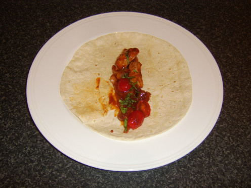 Diced leg of pork is stir fried in a spicy szechuan tomato sauce and served in a tortilla wrap