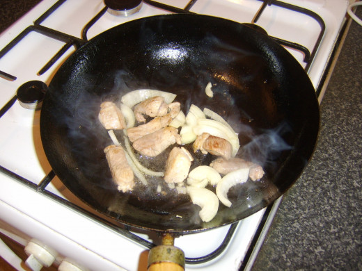 Stir frying onion with pork