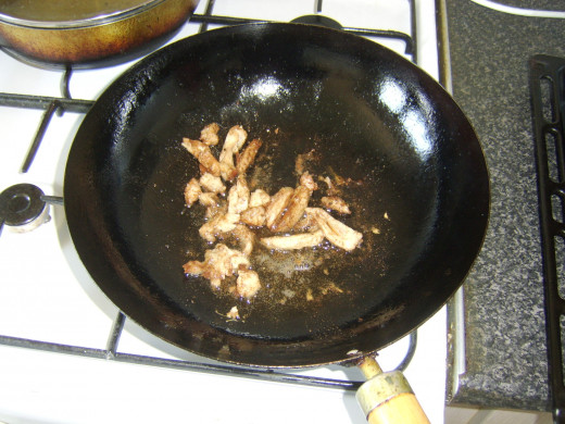 Stir frying the pork with Chinese 5 spice