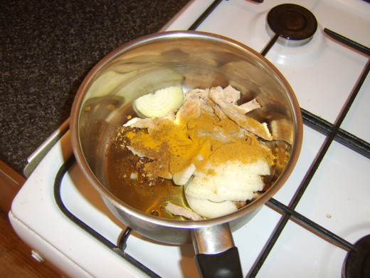 Pork, onion and spices are added to hot oil