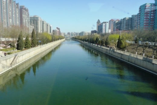Downtown Beijing showing modern buildings and a canal running through the city