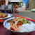 Rice vermicelli salad with fresh vegetables, ground red chillies, sweet barbecued pork, ground peanuts, and chopped pickled vegetables.