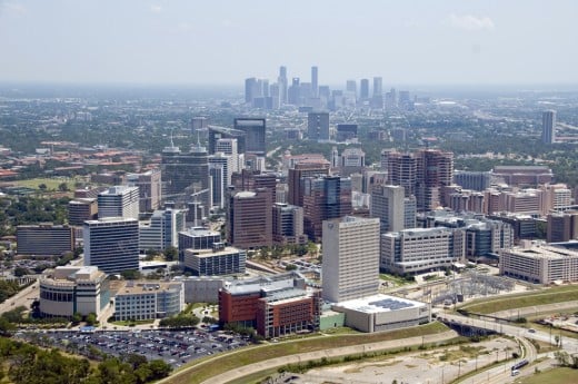 Houston Medical Center with 21 hospitals in the forefront, downtown Houston, in the background.